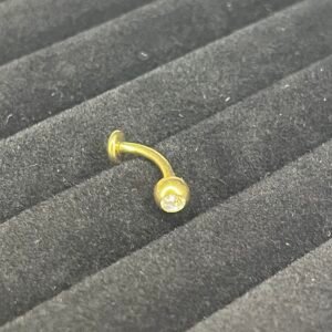 Lola - Banane nombril floating belly piercing en titane doré avec un cristal